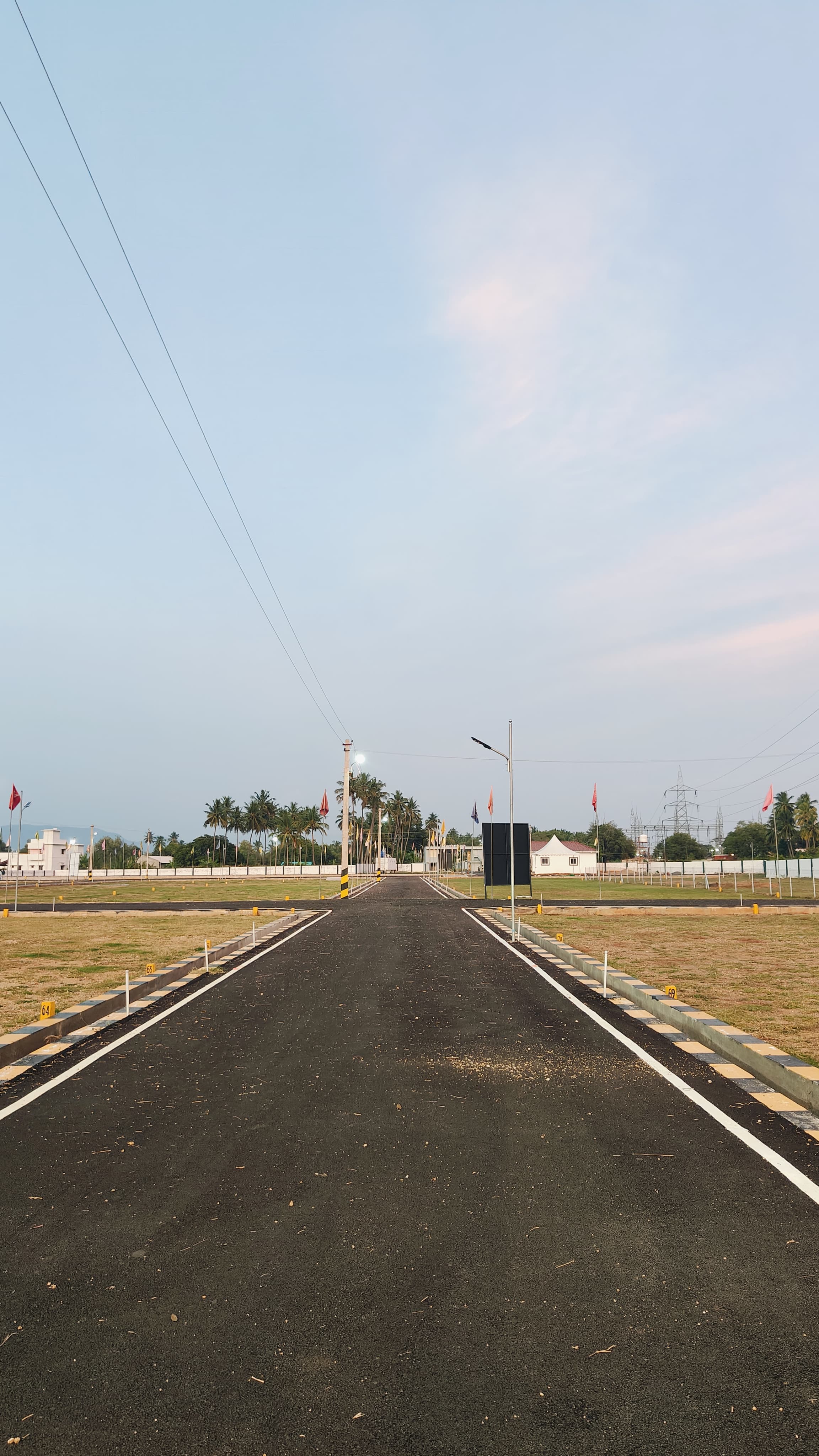 Open, airy Valapadi plot layout at dusk, Salem district